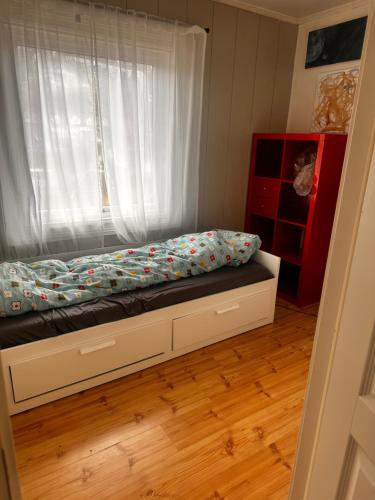 a bed in a room with a window at Asleep in the Valley Villa in Oslo