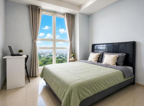 a bedroom with a large bed with a large window at Residencia Nova, Jakarta in Jakarta