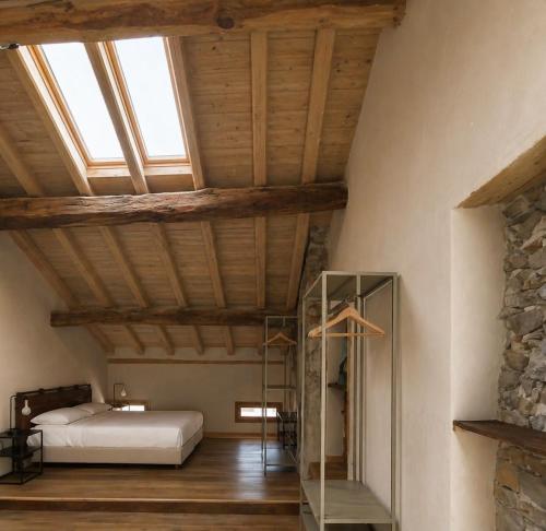 a bedroom with a bed and a vaulted ceiling at DIMORA STORICA ZACCHI D'ARRIGO in Belluno