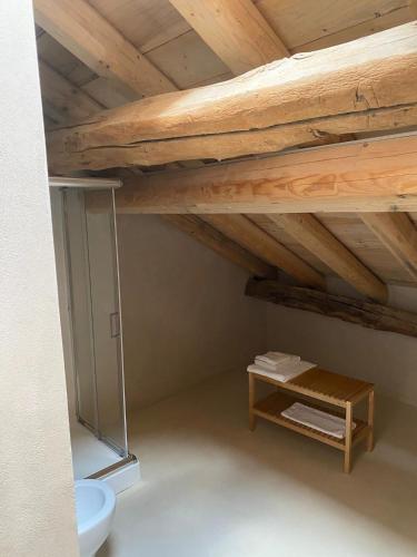 a room with a wooden ceiling and a table at DIMORA STORICA ZACCHI D'ARRIGO in Belluno