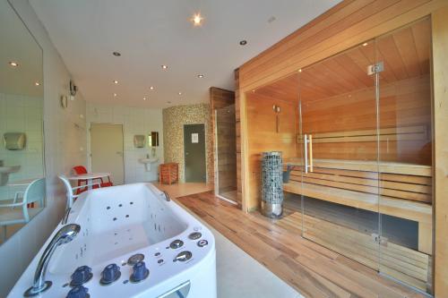 a kitchen with a stove and a tub in a room at Penzion Stará Vápenka in Unter Swina