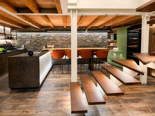 a dining room with a table and benches at Fenat - Alpine Living in Introd