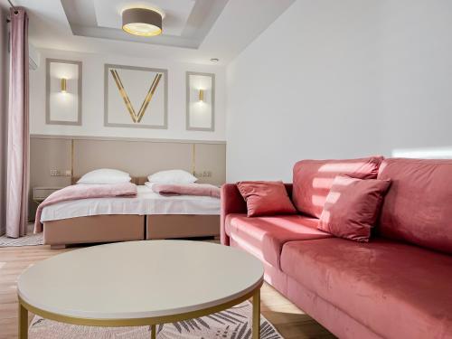 a living room with a couch and a table at VENETIA-Rooms in Biecz