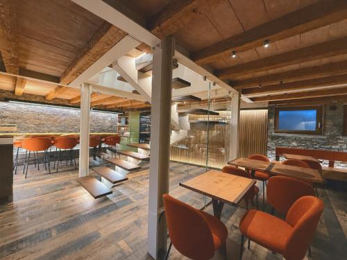 a restaurant with wooden floors and chairs and a table at Fenat - Alpine Living in Introd
