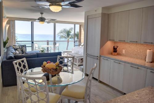 a kitchen and a living room with a table and chairs at Mana Kai 711C in Wailea
