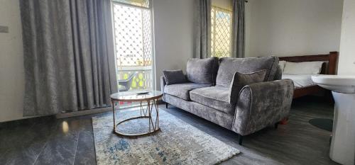 a living room with a couch and a table at Tulia Stays in Mtwapa
