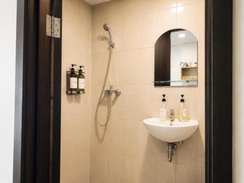 a bathroom with a sink and a shower at Loft Privato, Jakarta in Jakarta