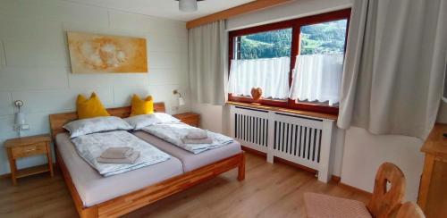 a bedroom with a bed and a large window at Ferienwohnung Schädler in Tschagguns
