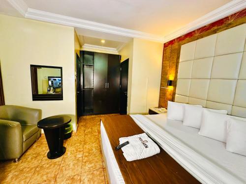 a hotel room with a bed and a couch at Presken Hotel K-ONE, Bank Anthony, Lagos in Ikeja