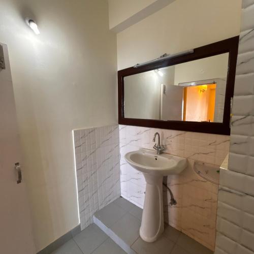 a bathroom with a sink and a mirror at Hotel Aman in Nārkanda