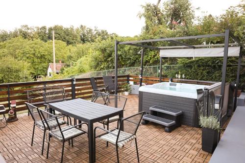a patio with a table and chairs and a hot tub at Villa Ferra in Virovitica