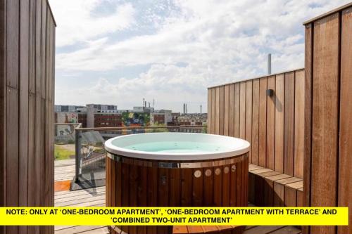 a hot tub on the balcony of a building at Nørrebrogade 209 in Copenhagen