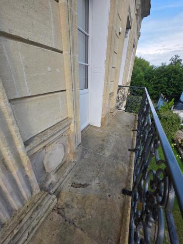 a porch of a building with a fence at Villa Aestival in Saint-Symphorien