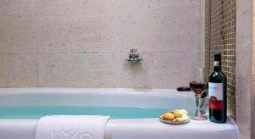 a bottle of wine and a glass of wine and a bottle of wine at Lhasa Hotel in Lhasa