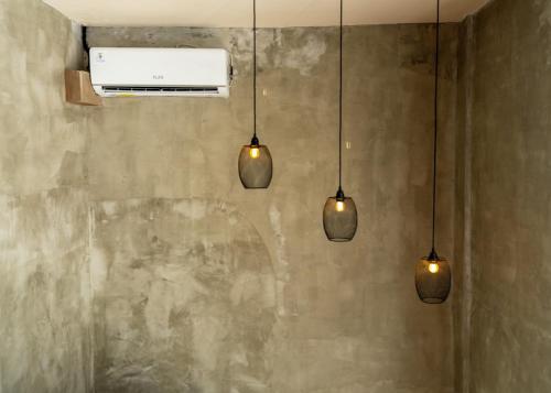 a group of five lights hanging from a wall at Iron Wave Uluwatu in Bingin Beach