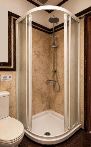 a shower in a bathroom with a toilet at Max Residence in Pattaya