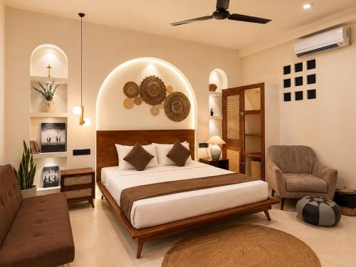 a bedroom with a large bed and a chair at The Neylipz - Fully Air Conditioned 3 bedroom Apartment in Weligama