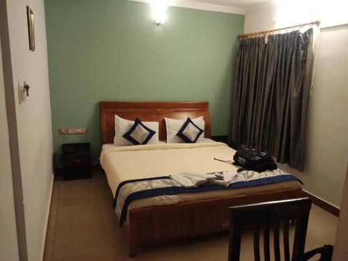 a bedroom with a bed with a phone on it at FabHotel City Inn in Hyderabad