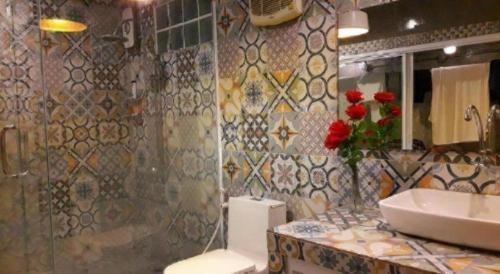 a bathroom with a sink and a toilet and a shower at The State Resort in Ban Wat Phrik (1)