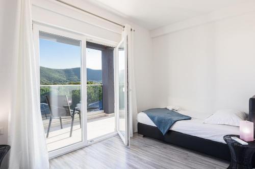 a bedroom with a bed and a sliding glass door at Villa Gabriel - Dicmo in Dicmo
