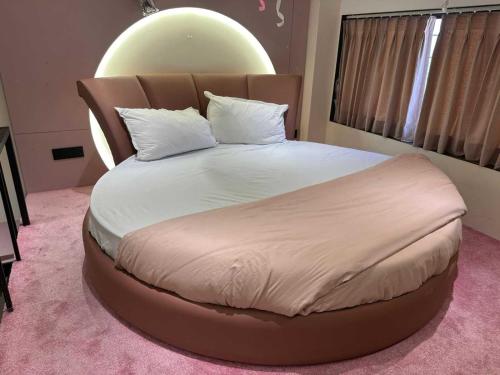 a bedroom with a large bed with a large orb on the wall at Collection O Airport Road Formerly Hotel Nano Pod in Surat