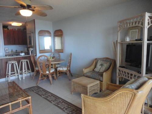 a living room with a couch and a tv and a table at Maui Vista 1313 in Kihei