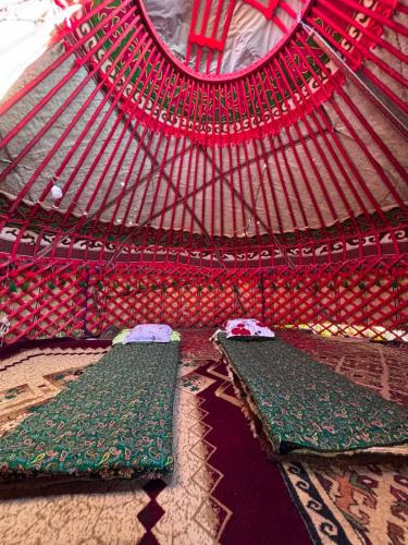 a room with two beds in a yurt at Yurtcamp AltynBalyk in Chayek