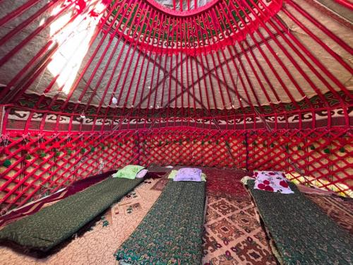 a room with three green beds in a yurt at Yurtcamp AltynBalyk in Chayek