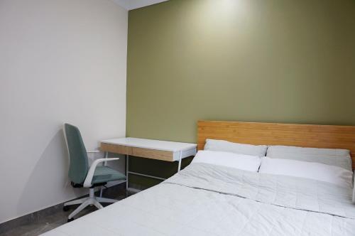 a bedroom with a bed and a desk and a chair at Emerald Oasis in Leanyer