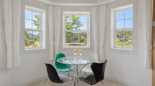 a dining room with a glass table and chairs at Taean Ocean Stay Pension in Taean