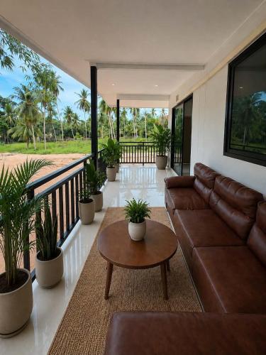 a living room with a couch and a table at Greenway in Hinkong