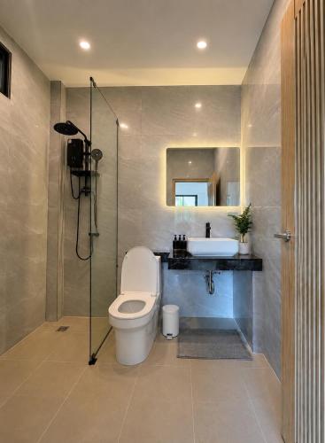 a bathroom with a toilet and a sink and a mirror at Greenway in Hinkong