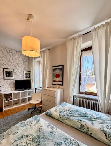 a bedroom with two beds and a television at Gästehaus Schiffmann 1895 in Brauneberg