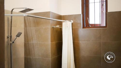 a bathroom with a shower with a shower curtain at Eagles Hideout Kandy in Bowala