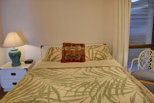 a bed with two pillows on it in a bedroom at Maui Vista 2207 in Kihei