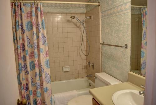 a bathroom with a shower and a toilet and a sink at Maui Vista 2207 in Kihei