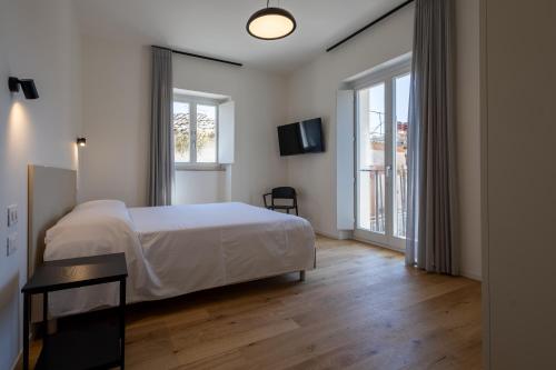 a bedroom with a bed and a large window at Palazzo Partenope in Vasto