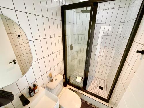 a bathroom with a toilet and a large mirror at 42 on Kavango Unit 24 in Swakopmund