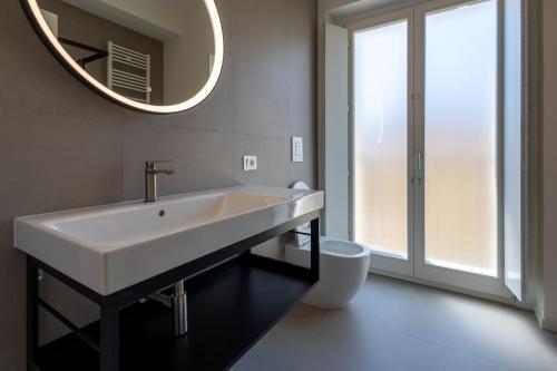 a bathroom with a white sink and a mirror at Palazzo Partenope in Vasto