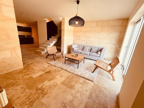 a living room with a couch and a table at Le Chai de Canteloup in Yvrac