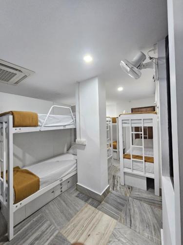 a room with two bunk beds in it at Lowfare Dormitory in Kozhikode
