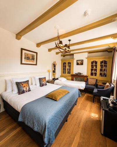 a bedroom with a large bed and a desk at de Campveerse Toren in Veere