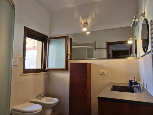 a small bathroom with a sink and a toilet at Santarcangelo Stay Your Perfect Base in Romagna in Santarcangelo di Romagna
