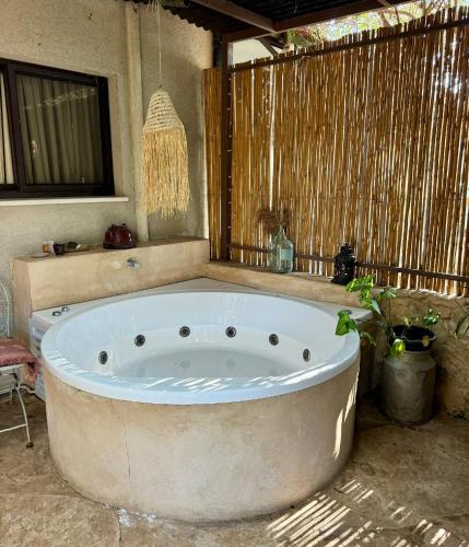 a large bath tub in a room with at Kirshner Farm in Bet Leẖem HaGelilit
