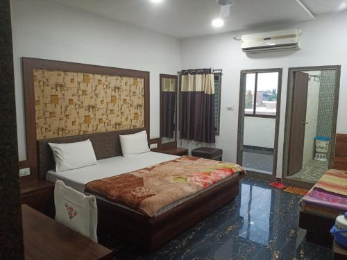 a bedroom with a large bed in a room at Hotel Gungun Jawai, Sumerpur in Sheoganj
