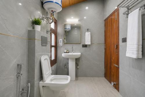a bathroom with a white toilet and a sink at The Elena Dogri Homes, A Comfortable & Luxury Stay - Best Selling Cottage 2025-26 in Shimla