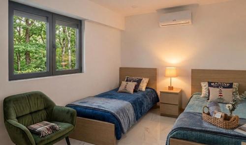 a bedroom with a bed and a chair and a window at Casa Machado in Cabeceiras de Basto