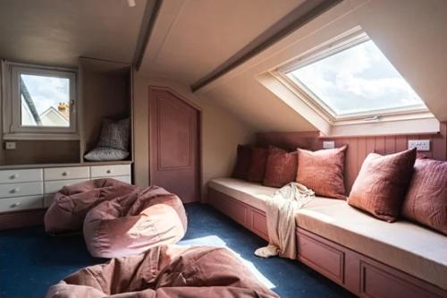 a room with two beds in a room with a window at Fairlawn House in Amesbury