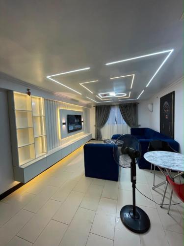 a living room with a blue couch and a table at Teddy apartment in Lagos
