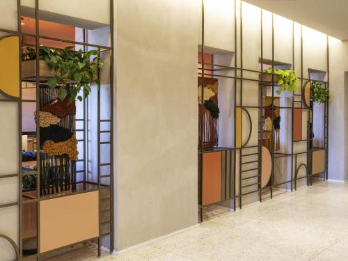 a hallway with glass shelves with plants on them at Mercure Rio Boutique Hotel Copacabana in Rio de Janeiro